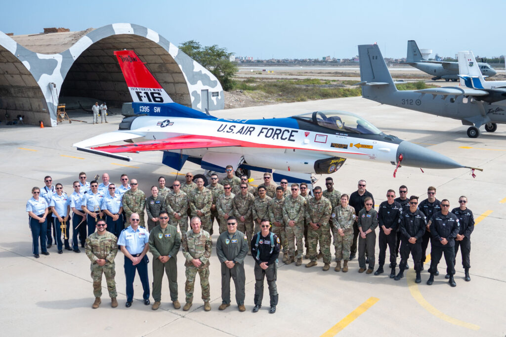 U.S. Air Force active duty and civilian personnel pose for a photo during the Festival Aereo Chiclayo 2024 in Chiclayo, Peru, June 17, 2024. The airshow team included the F-16 Viper Demonstration Team, the premiere rock band of the Air Force Band Max Impact, Spanish-speaking interpreters, 20th Security Forces Squadron personnel, 635th Materiel Maintenance Squadron and 819th RED HORSE Squadron civil engineers and exercise Resolute Sentinel 24 participants. The success of the airshow would not have been possible without the multiple agencies, hailing from bases across the Air Force, working to ensure the success of the American contributions. (U.S. Air Force photo by Senior Airman Meghan Hutton)